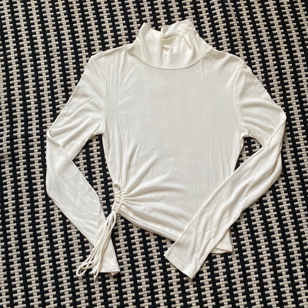 Turtleneck long sleeve top with drawstring on side